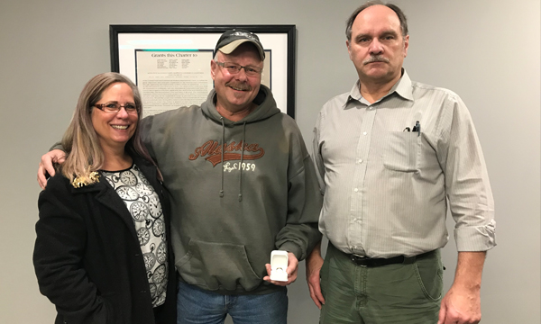 Dennis (middle) picks up his new 401 retirement ring and is accompanied by his Union Rep Zig and his lovely wife Karen
