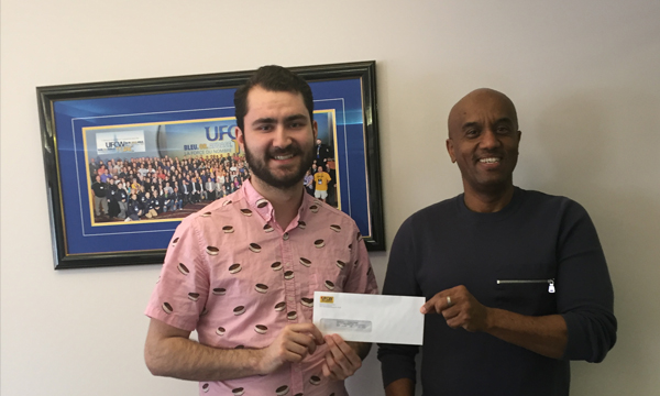Jonathan (on left), pictured here with his Union Rep Abdi, receives his Robert McWilliams Memorial Scholarship cheque