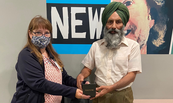 Amarjit receives his retirement gift from his union rep Cheryl