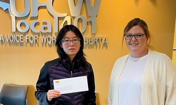 Helen drops into the union office to pick up her scholarship cheque from Union Representative Michelle