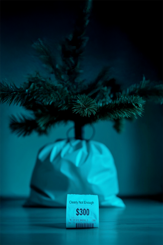 A Christmas tree with a nothing but a grocery bill under it.