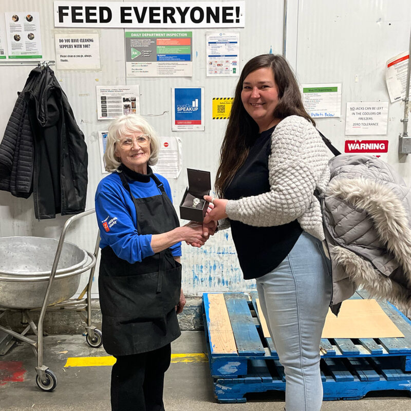 Ashley Speer presents Carol Lee with her retirement watch.