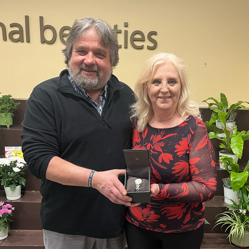 Rick Schneider presents Gordina Runtas with her retirement watch.