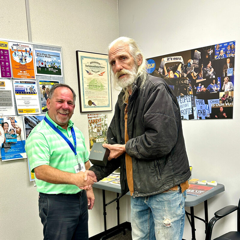 Peter Isiah presents George Bellows with his retirement watch.
