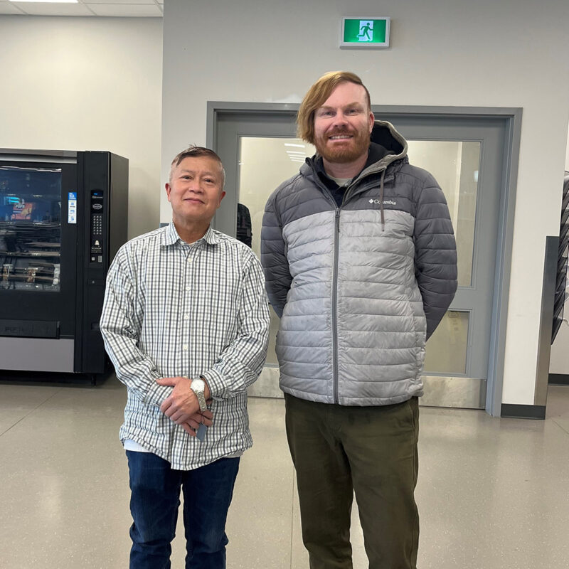 Jeff Ible presents Lee Vuong with his retirement watch.