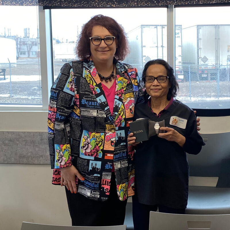 Teresa Ludwig presents Vutha Chea with her retirement watch.