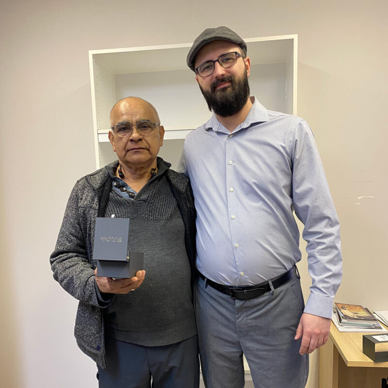 Taylor Rittinger presents Tiburico Ochoa Campos with his retirement watch.