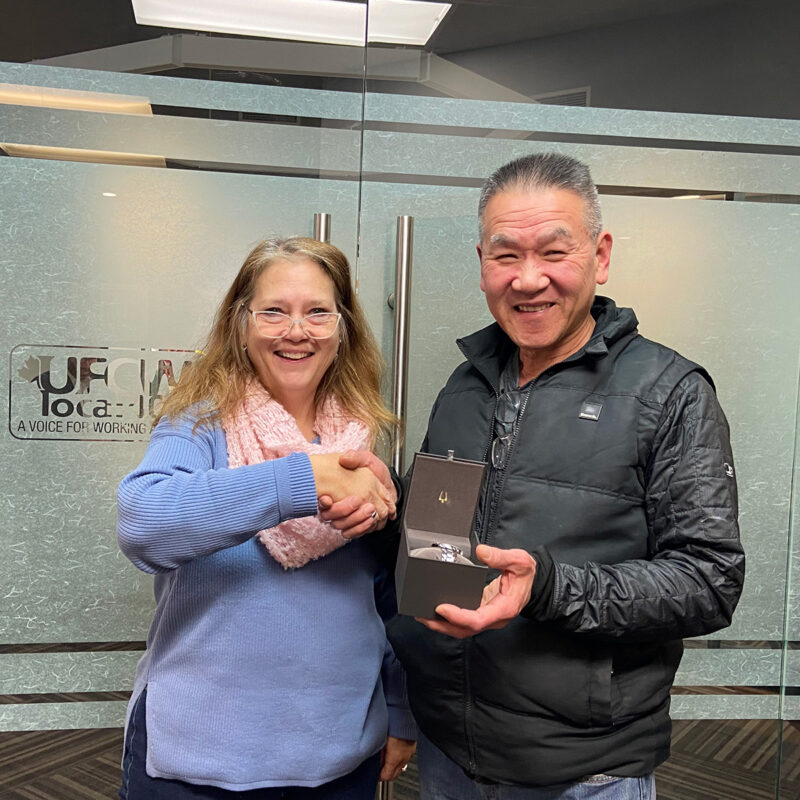 Cheryl Watamaniuk presents Tri Van Nguyen with his retirement watch.