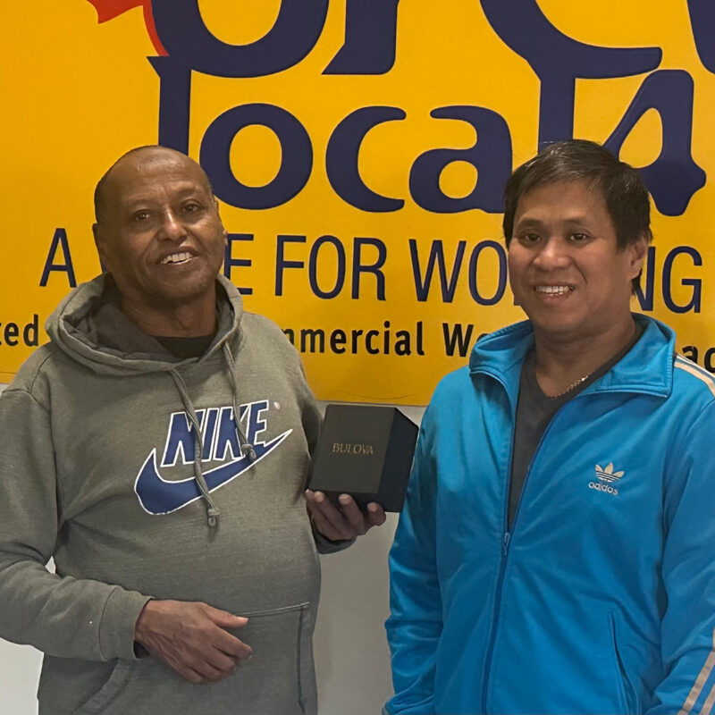 Alain Mendoza presents Gielbert Agustin with his retirement watch.