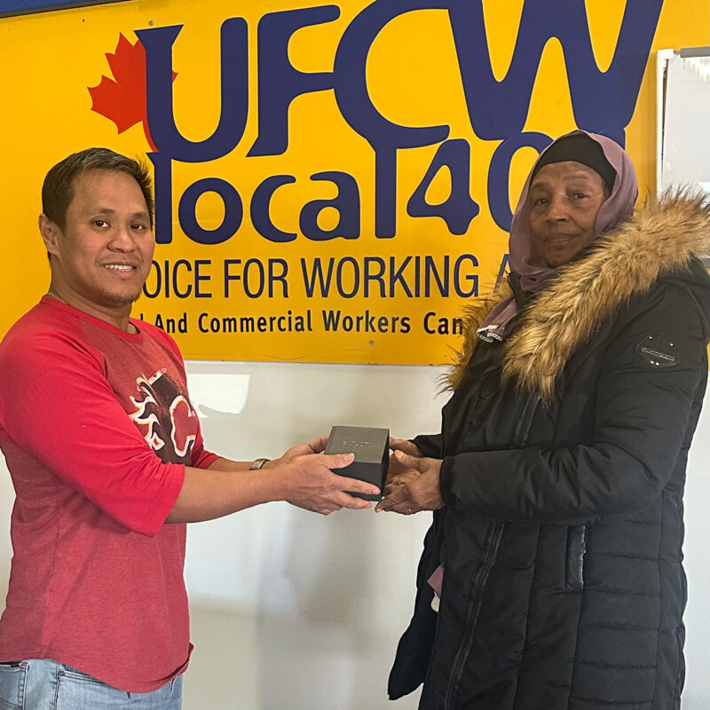 Alain Mendoza presents Kemero Omar with her retirement watch.