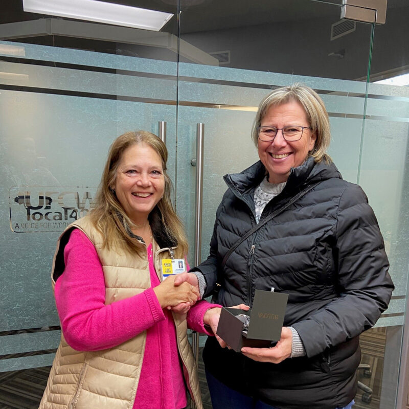 Cheryl Watamaniuk presents Angie Grendowicz with her retirement watch.